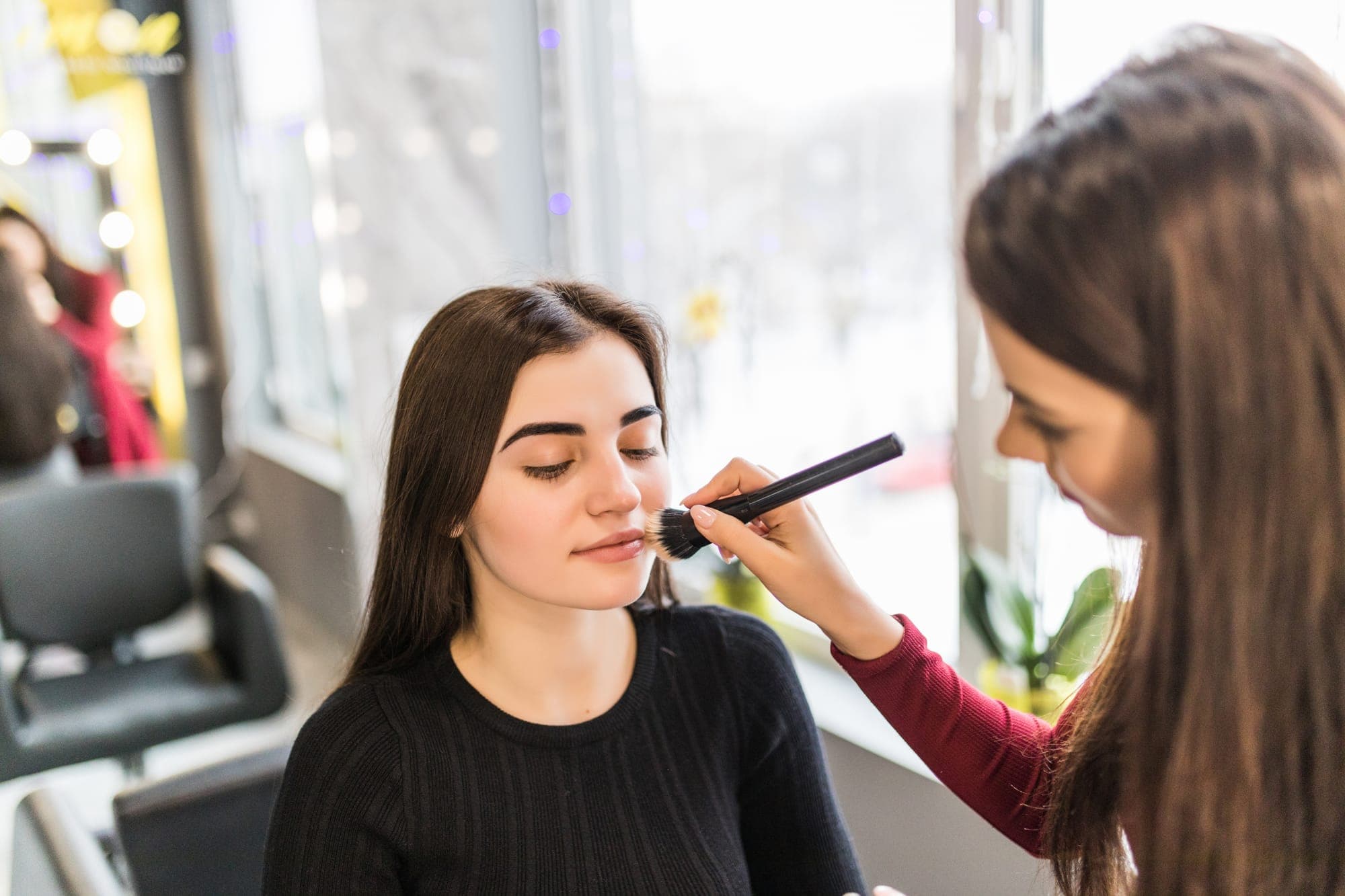 Setting spray and final touch-ups locking in a 12-hour bridal finish